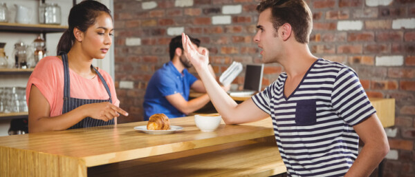 Two people in conflict in a cafe
