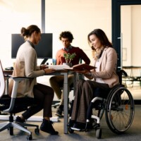 Businesswoman with disability and her female colleague