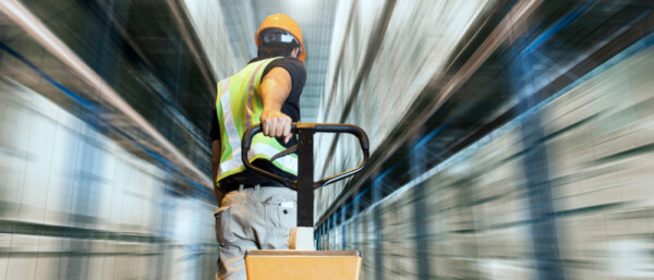 Speeding motion of warehouse worker unloading pallet goods