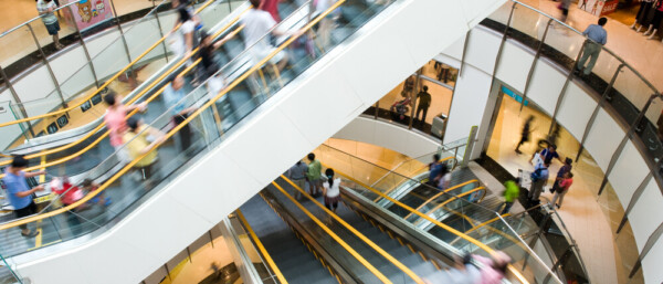 People in motion in escalators at the modern shopping mall