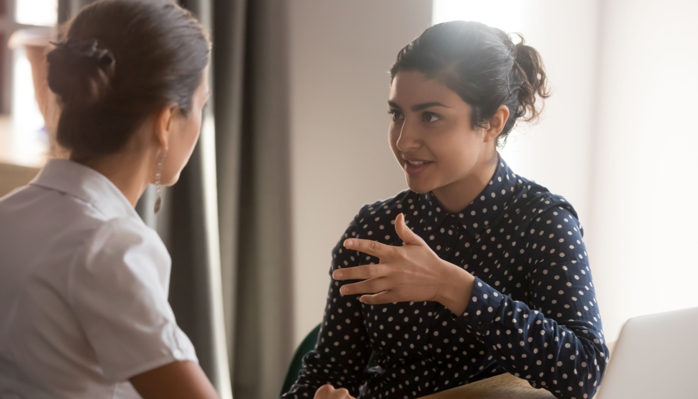 Coach talking to female colleague