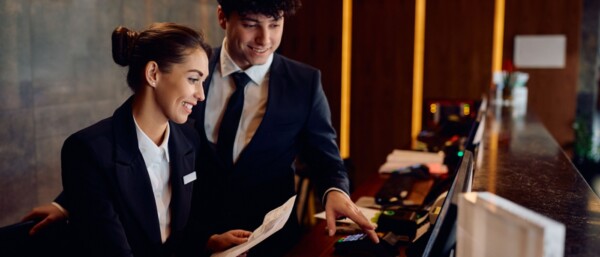 Hotel receptionist apprentice with manager